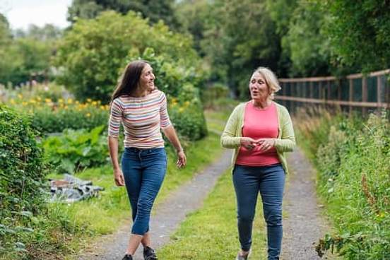 mother and daughter walking in park