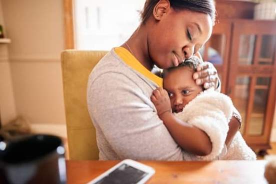mother consoling baby daughter