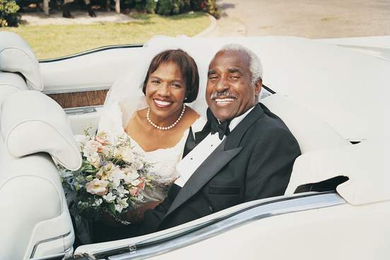 older couple sitting in car after just getting married