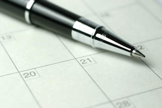 pen resting on calendar page