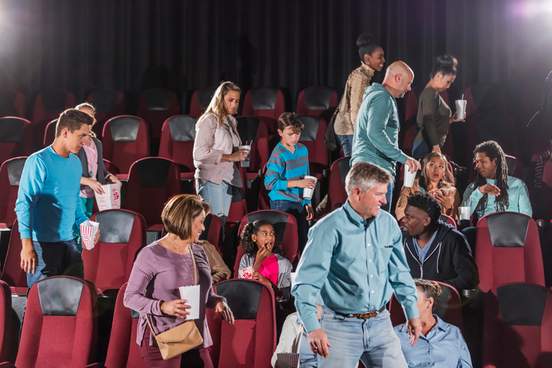 people leaving a crowded theater