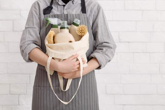 person embracing bag of cleaning products