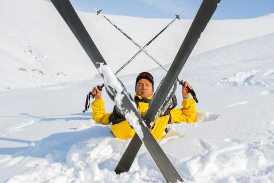 person on skis has fallen backwards