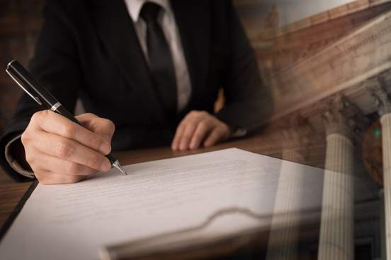 person sitting at desk writing