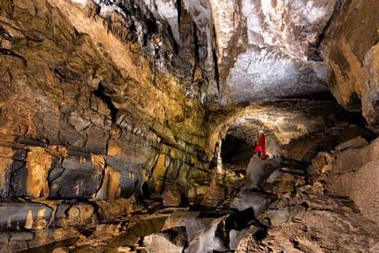 person standing in large cave