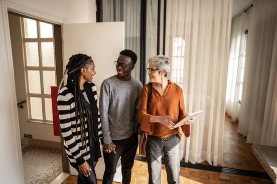 realtor showing apartment to young couple