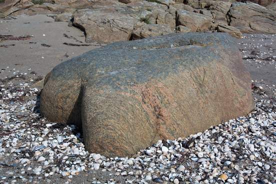 rock in the sea shaped like buttocks