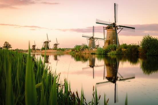 row of old fashioned dutch windmills