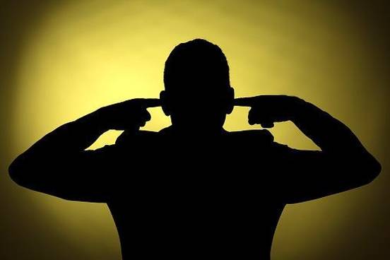 silhouette-of-man-fingers-in-ears