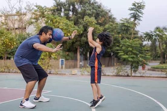son shooting basketball straight into fathers head