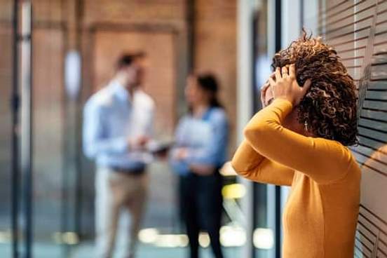 stressed woman with head in hands