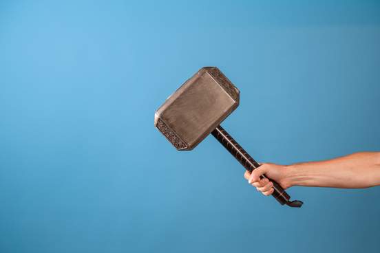 the scandinavian hammer of thor mjolnir in a mans hand 