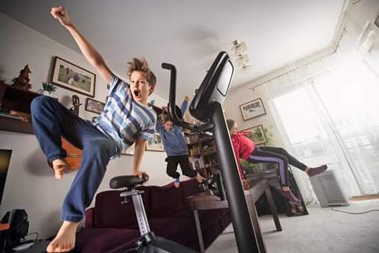three children going wild in a living room