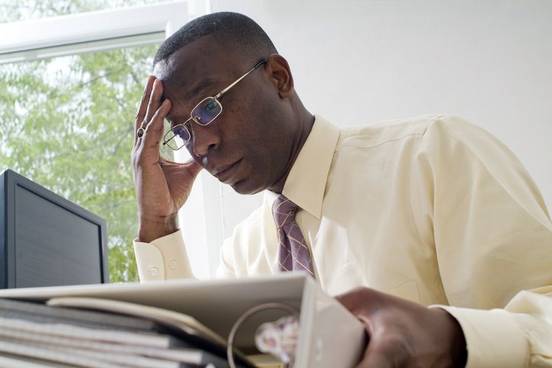 tired man at desk photo