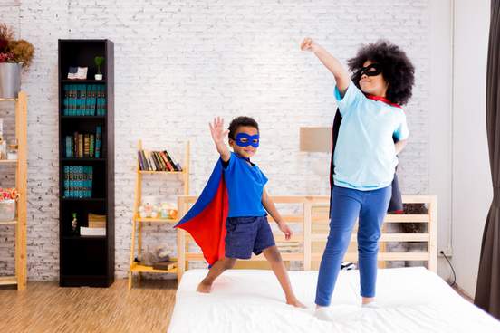 two kids dressed in superhero outfits exuding confidence