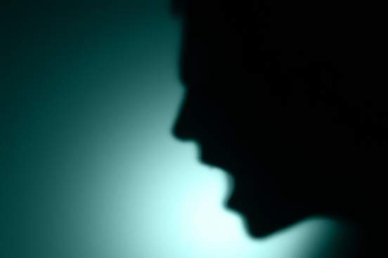 unfocused image of a man yelling in rage