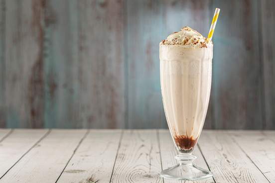 vanilla milkshake with whipped cream and chocolate sauce