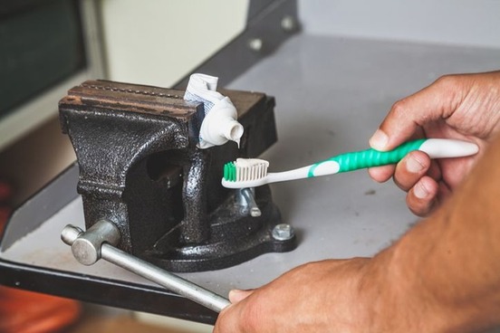 vise squeezing toothpaste photo