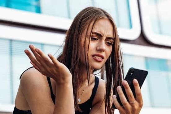 woman annoyed by something on her phone
