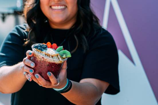 woman holding acai food bowl