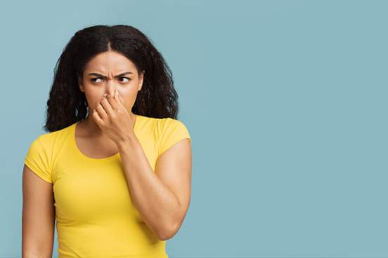 woman holding her nose