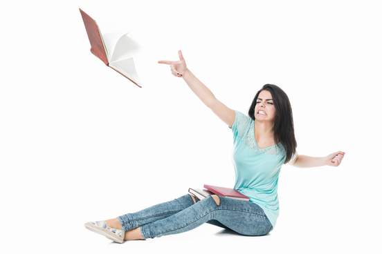 woman throwing book away from her in anger