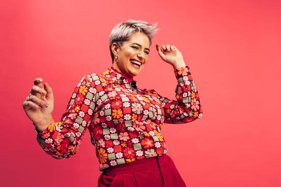 woman with fancy shirt dancing confidently