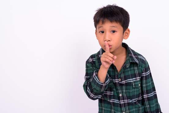 young boy shushing