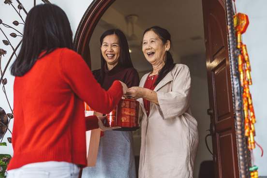 young woman visiting grandparents and getting gift