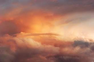 a beautiful cloudscape with colors of orange and purple signifying sunset