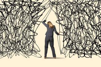 a business woman being tangled up in loose lines and struggling