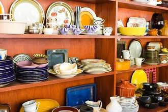 a cabinet full of vintage pottery piece collection