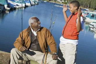 a child with his hands stretched out describing something to an elder