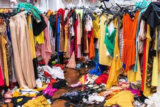 a closet with clothes thrown all over the place