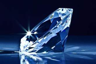 a diamond laying on its side gliting against the dark background