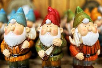 a group of cute smiling ceramic gnomes