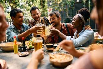 a group of friends gathered together for dinner enjoying each others company