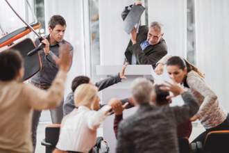 a group of office workers physically fighting or defending themselves against attacks