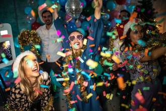 a group of party goers having a good time surrounded by confetti