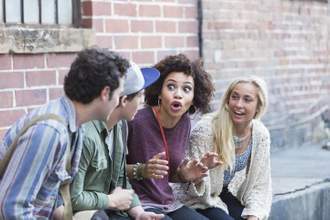 a group of young adults sitting around talking