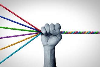 a hand holding multiple strings that become twisted together