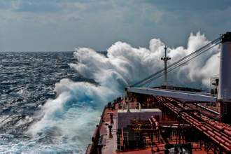 a large ship breaking through ocean waves
