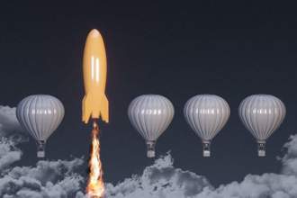 a lineup of hot air balloons with an orange rocket in the sky