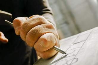 a person chiseling numbers into stone
