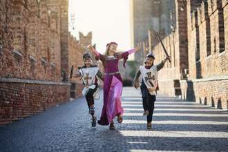 a princess and her young knights running through the castle grounds