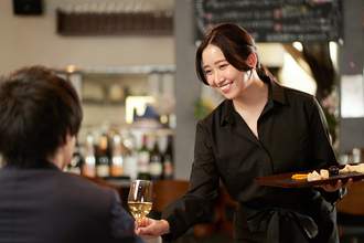 a server brings a customer wine