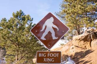 a sign warning hikers about big foot crossing
