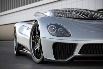 a silver sports car on black tile floor