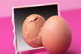 a smooth egg looking into a mirror and seeing a cracked version of themselves