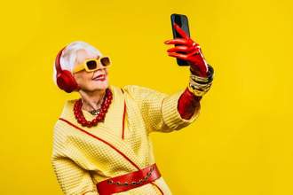 a stylish older woman posing for a selfie